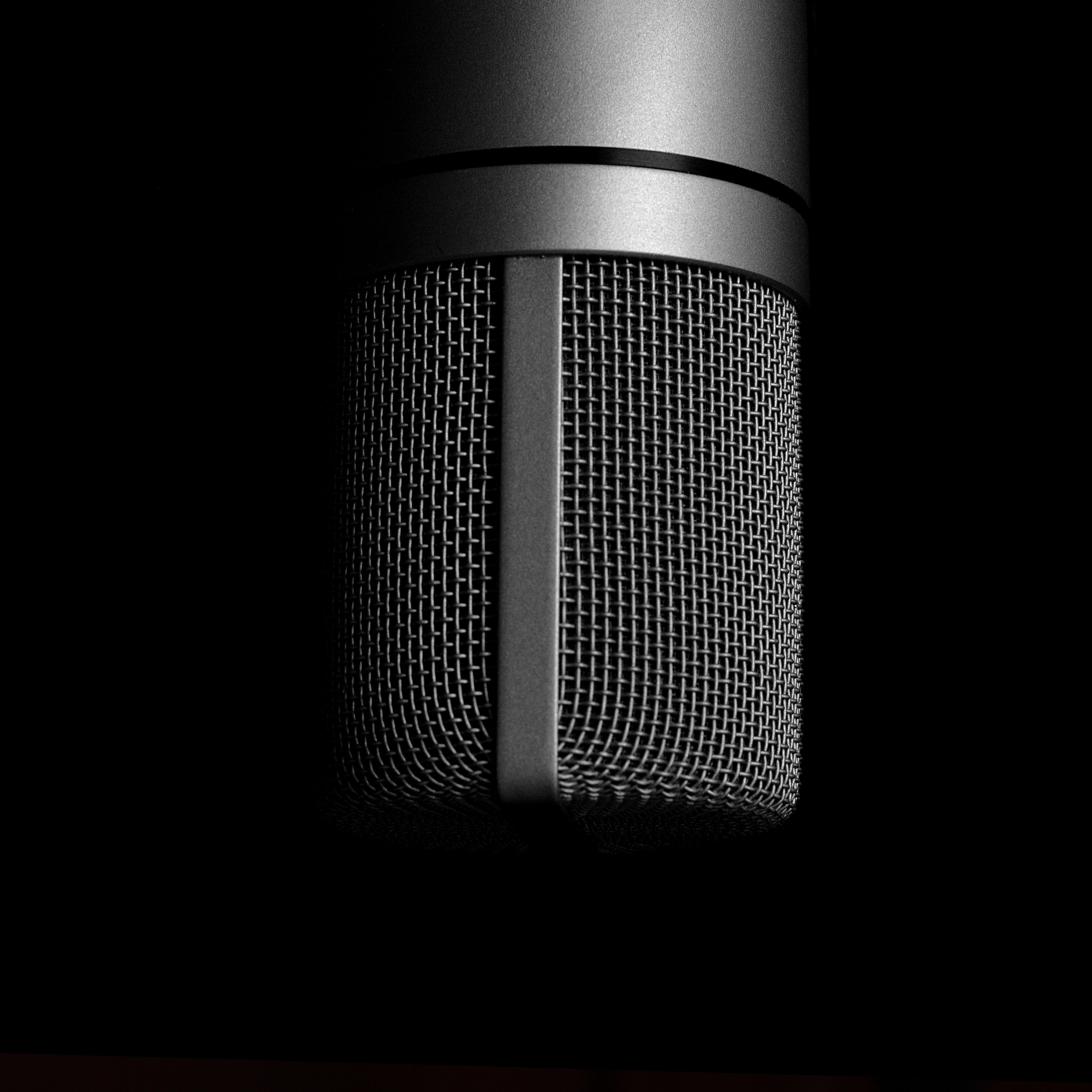 extreme close up of dark grey coloured Condenser Microphone against black background