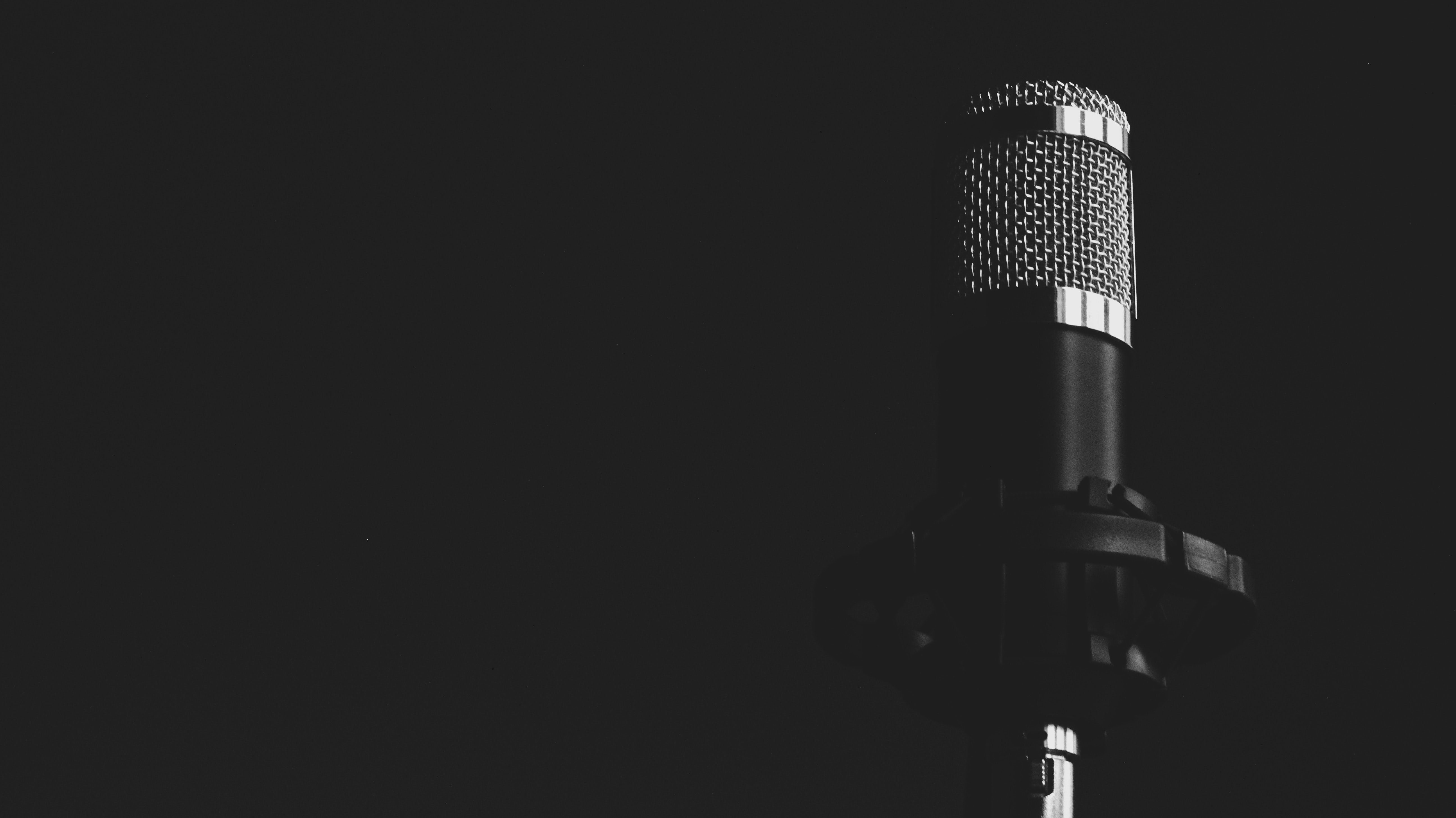 Grayscale photograph of Condenser Microphone in front of black background